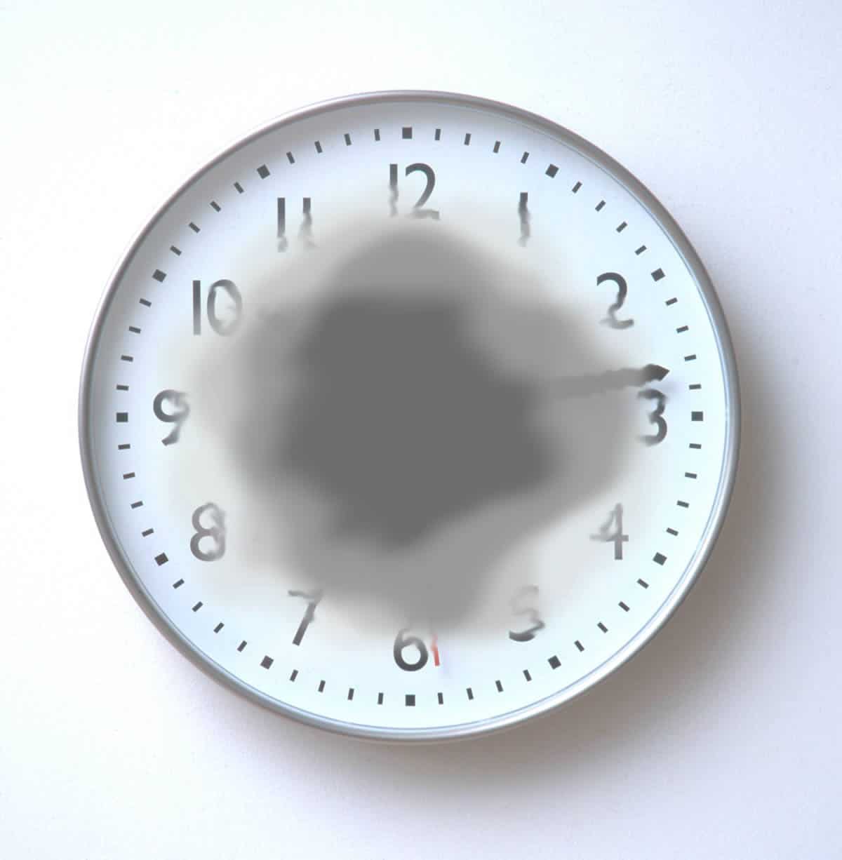 Clock with dark, blurred center to represent vision loss from macular degeneration