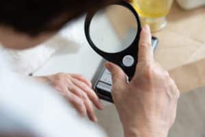 Senior woman reading with magnifying glass
