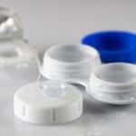 Contact lense with solution and case on table