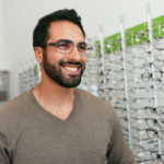 Man Trying On Eyeglasses In Optics Store