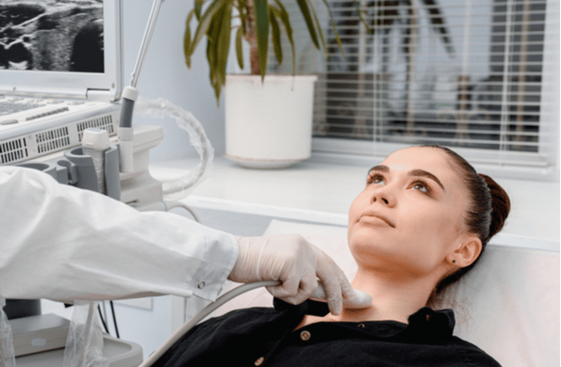 diagnostic center making ultrasound thyroid gland test.