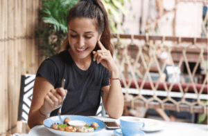 woman eating at restaurant table healthy food