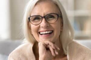 A woman wearing glasses and smiling