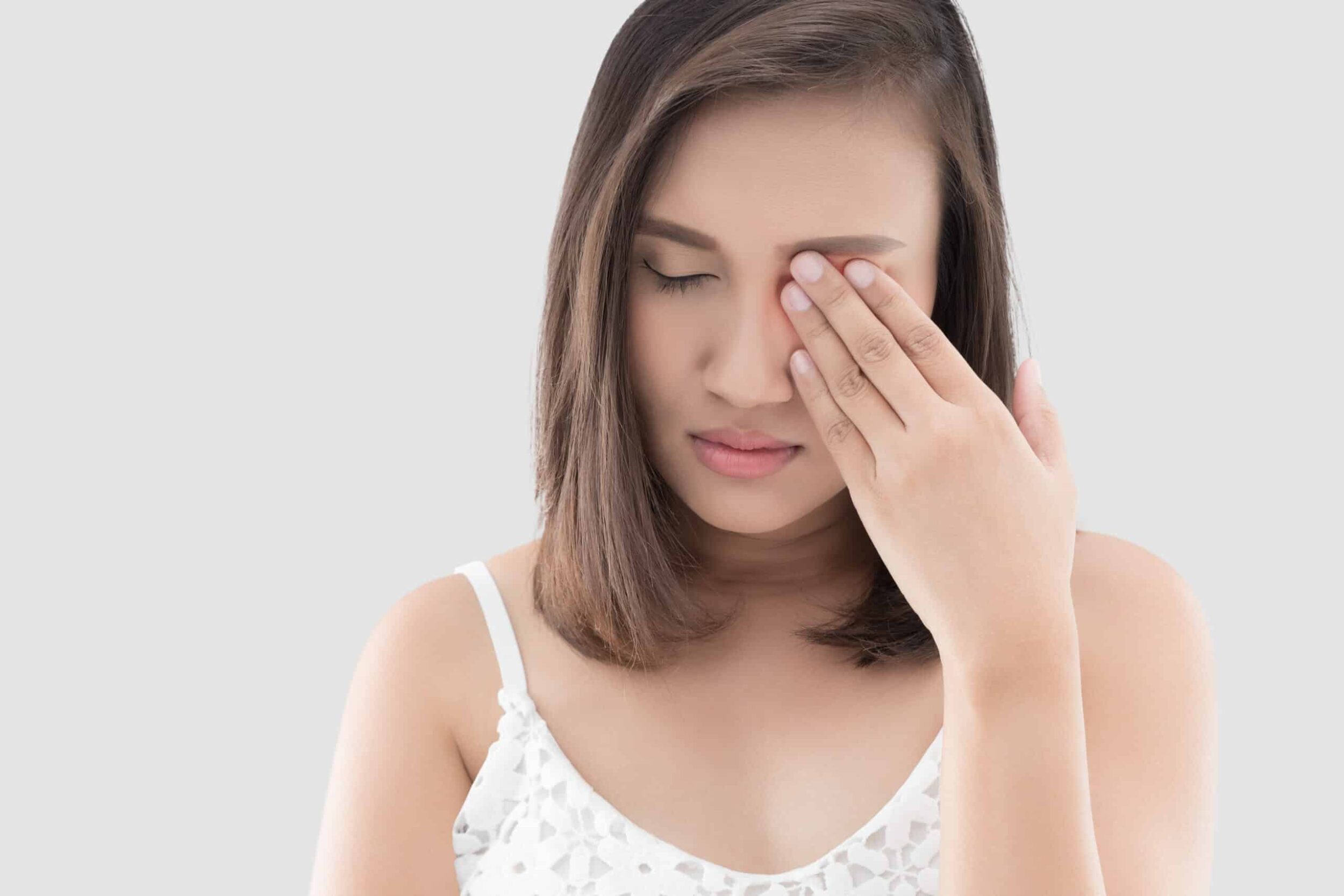 A woman covering her eye after orbital trauma in Stockton, CA