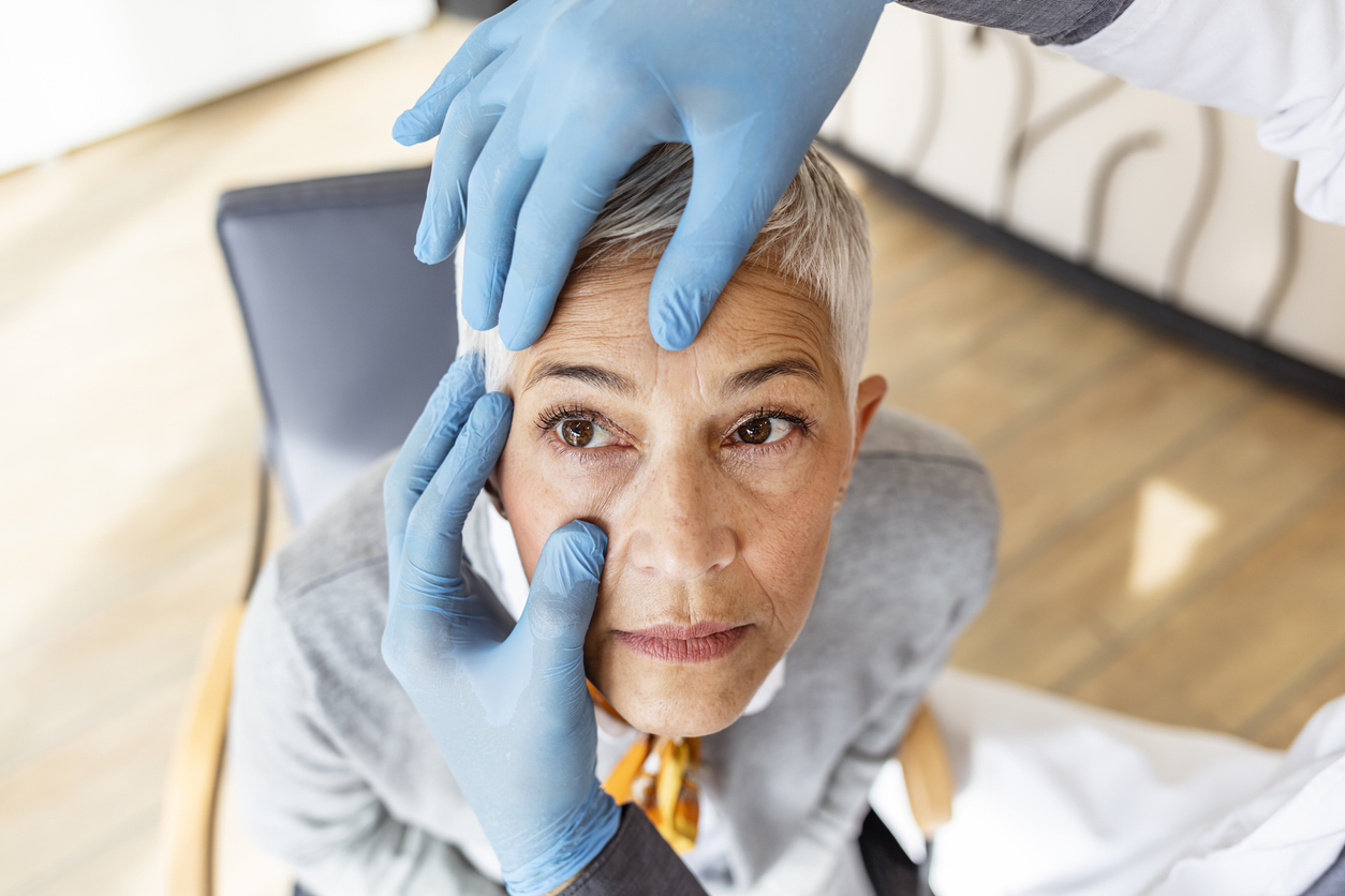 Close-up of an older woman having an eye exam as part of her ongoing glaucoma treatment.